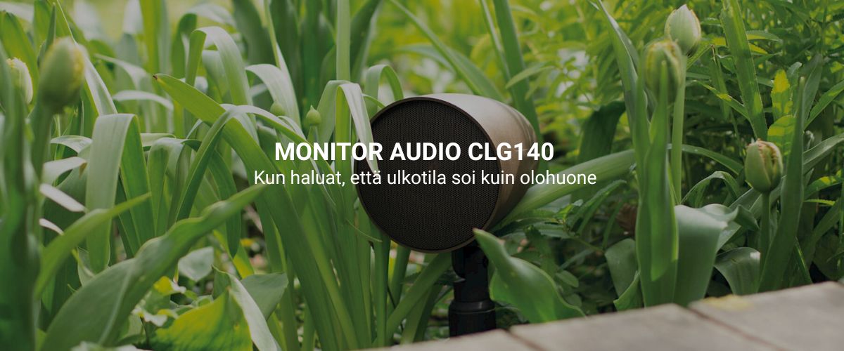Monitor Audio CLG140 säänkestävä kaiutin vihreän puutarhakasvillisuuden keskellä, asennettuna maapiikillä siististi näkymättömäksi